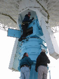 Jonathan Emmett gets training on how to level the S-Pol antenna.  Don Ferraro and Al Phinney provide guidance. (R.Rilling, 27-Nov-2001)